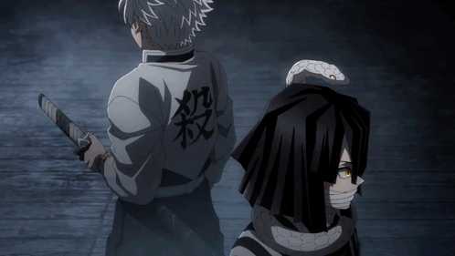 A Man Holding A Sword Stands Next To Another Man With A Snake On His Back GIF