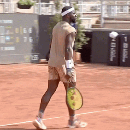 a man holding a tennis racquet on a court
