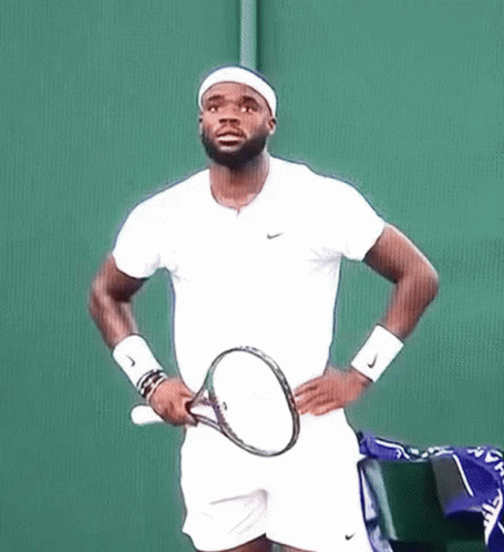 a man holding a tennis racquet on a court
