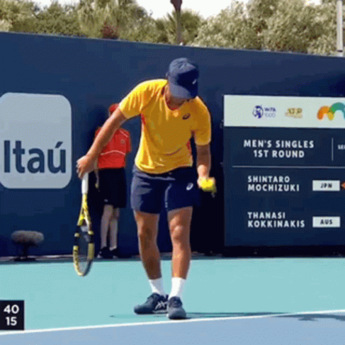 A Man Holding A Tennis Racquet On A Tennis Court With A Sign That Says Itau In The Background GIF