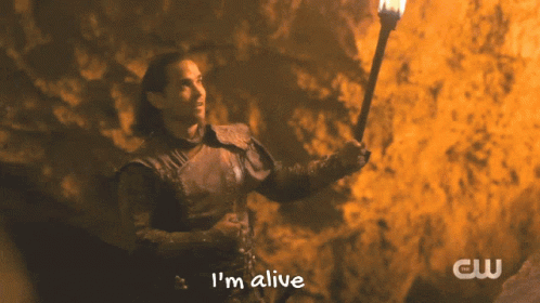 A Man Holding A Torch With The Words I 'M Alive On The Bottom GIF