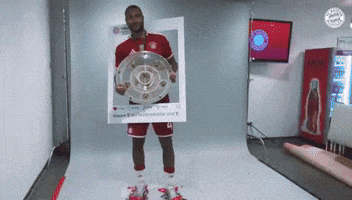 a man holding a trophy in a picture frame