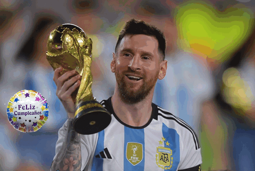 A Man Holding A Trophy With A Feliz Cumpleanos Balloon In The Background GIF