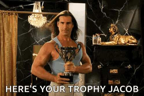 A Man Holding A Trophy With The Words Here 'S Your Trophy Jacob GIF