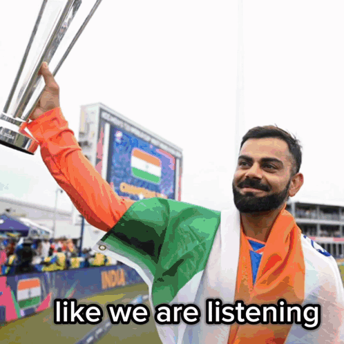 A Man Holding A Trophy With The Words Like We Are Listening Underneath Him GIF
