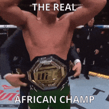 A Man Holding A Ufc Belt With The Words The Real African Champ Below Him GIF