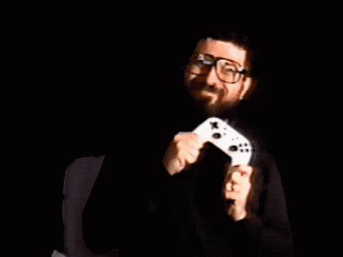 A Man Holding A Video Game Controller With The Words It 'S Game Night Written Above Him GIF