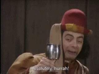 A Man Holding A Wine Glass With The Words Absolutely Hurrah Written Below Him GIF