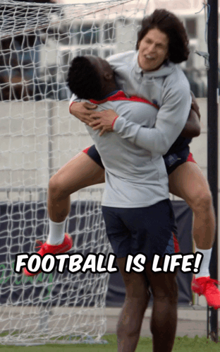 A Man Holding Another Man In His Arms With The Words Football Is Life Below Him GIF