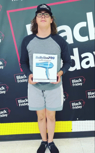 Man With Babyliss Hair Dryer In Front Of Black Friday Banner GIF