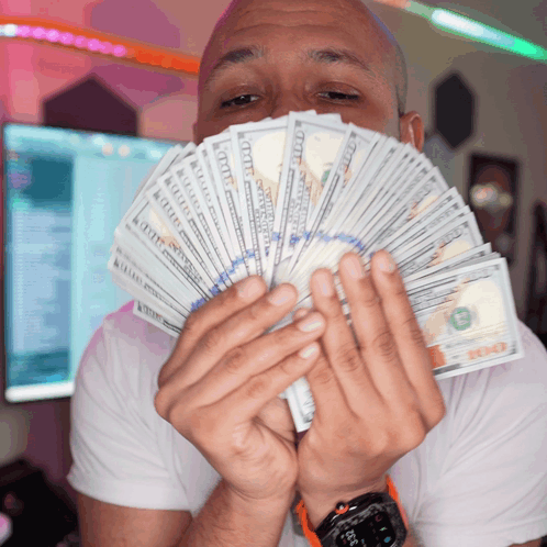 A Man Holds A Fan Of Twenty Dollar Bills GIF