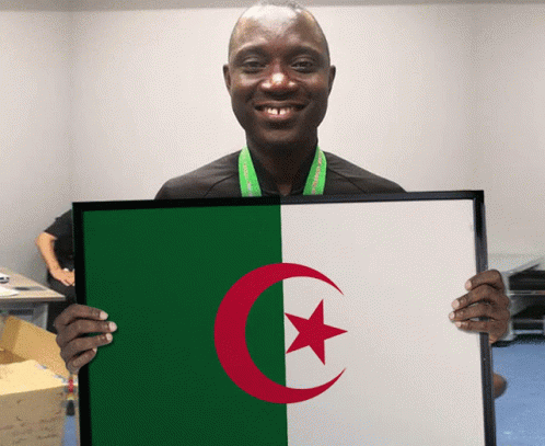 A Man Holds A Framed Picture Of The Algerian Flag GIF