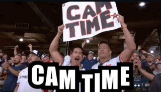 A Man Holds A Sign That Says Cam Time GIF