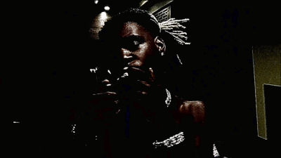 A Man Holds A Stack Of 100 Dollar Bills In His Mouth GIF