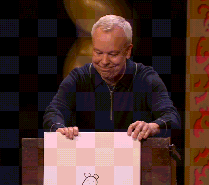 A Man Holds Up A Piece Of Paper With A Drawing Of A Bear On It GIF