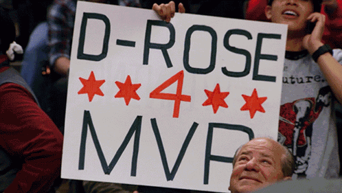 A Man Holds Up A Sign That Says " D-Rose 4 Mvp " GIF