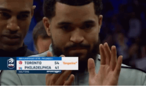 A Man Holds Up A Sign That Says Toronto Philadelphia 41 On It GIF