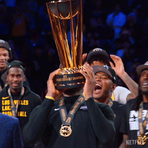 A Man Holds Up A Trophy That Says Netflix On It GIF