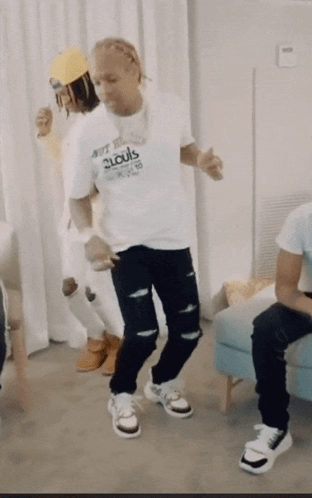 A Man In A 2Louis Shirt Is Dancing GIF