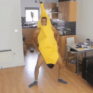 A Man In A Banana Costume Is Dancing In A Kitchen . GIF