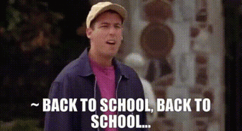 A Man In A Baseball Cap And Jacket Is Standing In Front Of A Building And Saying `` Back To School , Back To School . '' GIF