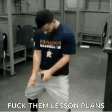 A Man In A Baseball Uniform Is Standing In A Locker Room With His Hands On His Hips . GIF