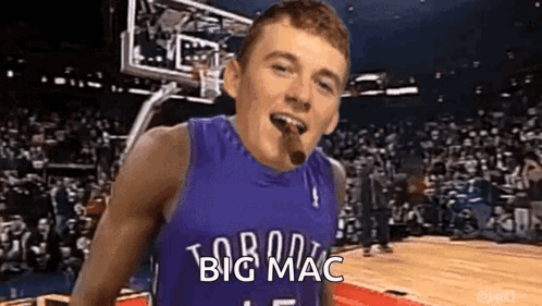 A Man In A Basketball Jersey Is Smoking A Cigar On A Basketball Court . GIF