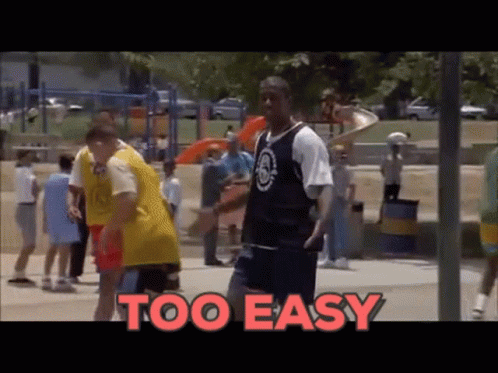 A Man In A Basketball Uniform Stands In Front Of A Playground With The Words Too Easy Behind Him GIF
