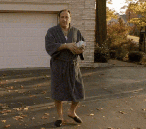 Man In Bathrobe And Slippers Holding Paper GIF