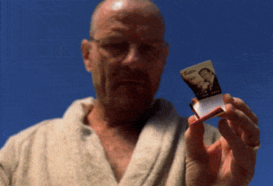 A Man In A Bathrobe Is Holding A Cigarette Pack With A Picture Of A Man On It GIF
