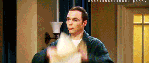 A Man In A Bathrobe Is Holding A Piece Of Paper In His Hand . GIF