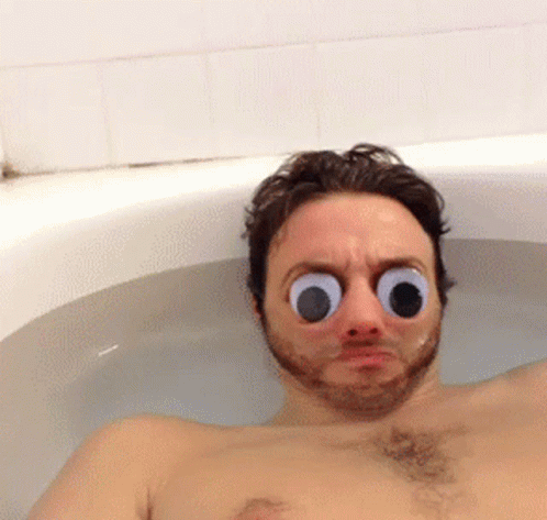 A Man In A Bathtub With Big Googly Eyes GIF