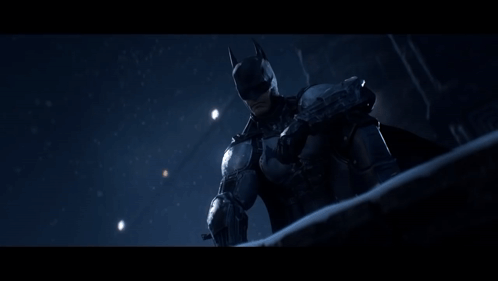 A Man In A Batman Costume Is Standing In Front Of A Building With A Sign That Says " Stars " GIF