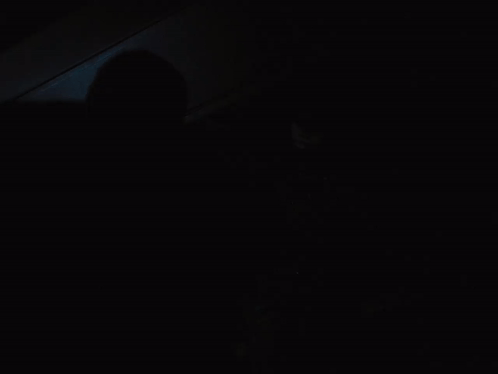 A Man In A Batman Costume Stands In The Dark GIF