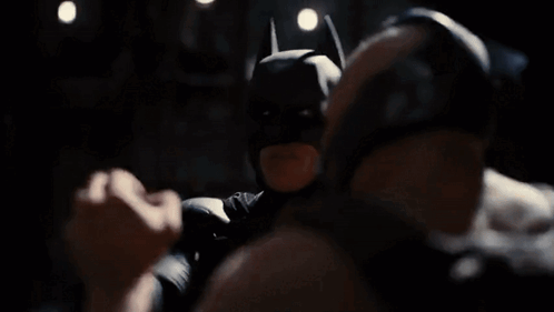 A Man In A Batman Mask Is Standing Next To Another Man In A Dark Room And Says Victory Has Defeated You . GIF