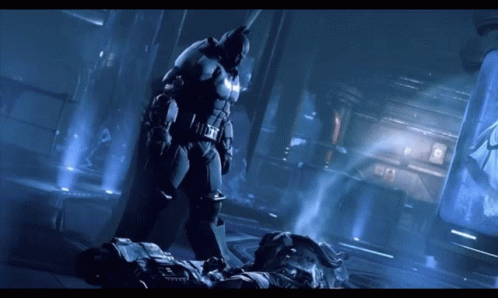 A Man In A Batman Suit Is Standing Next To Another Man GIF