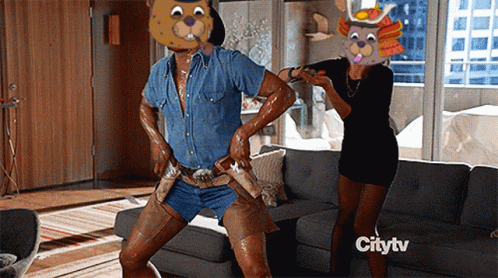 A Man In A Bear Mask Is Dancing In A Living Room With A Citytv Logo In The Background GIF