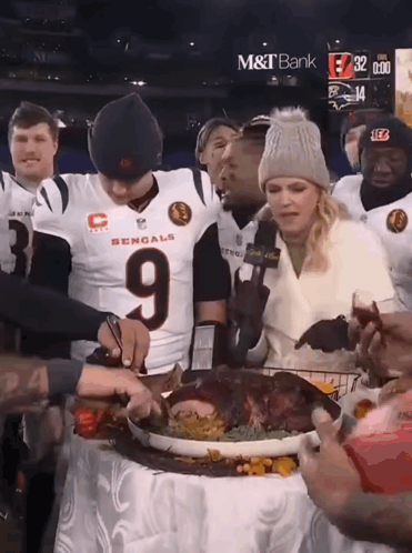 A Man In A Bengals Jersey Cuts A Turkey GIF