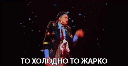 a man in a beret is standing in front of a microphone with the words to холодно to жарко written below him .