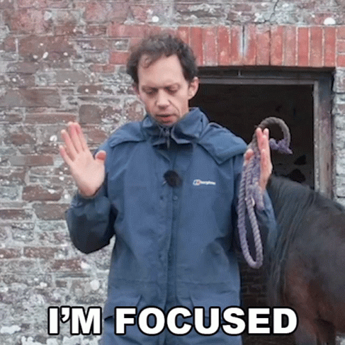 A Man In A Berghaus Jacket Holds A Rope In Front Of A Horse And Says " I 'M Focused " GIF