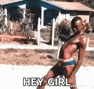 A Man In A Bikini Is Dancing On A Sidewalk And Says `` Hey Girl '' . GIF