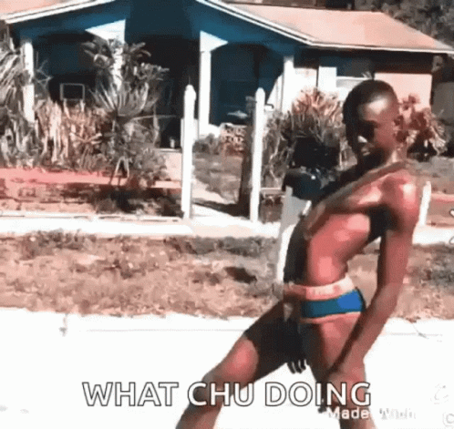 A Man In A Bikini Is Standing On A Sidewalk In Front Of A House And Says `` What Chu Doing '' . GIF