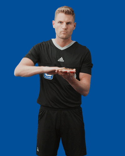 A Man In A Black Adidas Shirt Holds A Red Card GIF