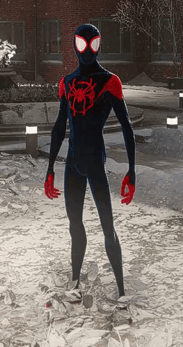 A Man In A Black And Red Spider-Man Suit Is Standing In The Snow GIF