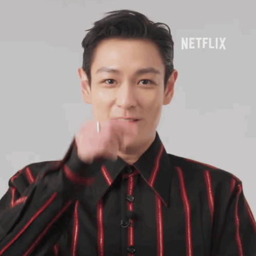 A Man In A Black And Red Striped Shirt With Netflix Written On The Bottom Right GIF