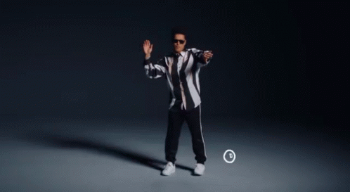 A Man In A Black And White Striped Jacket Is Dancing In Front Of A Circle With The Letter D On It GIF