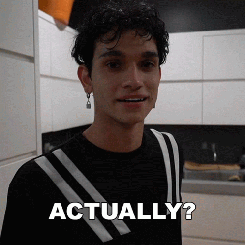A Man In A Black And White Striped Shirt Is Smiling And Says Actually GIF