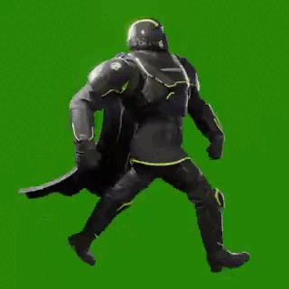 A Man In A Black Armor Is Walking On A Green Screen . GIF