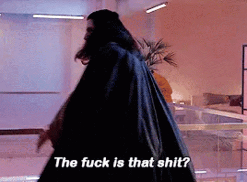 A Man In A Black Cape Is Walking In A Room And Says The Fuck Is That Shit . GIF