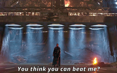 A Man In A Black Cape Stands In Front Of A Building With The Words " You Think You Can Beat Me " Above Him GIF